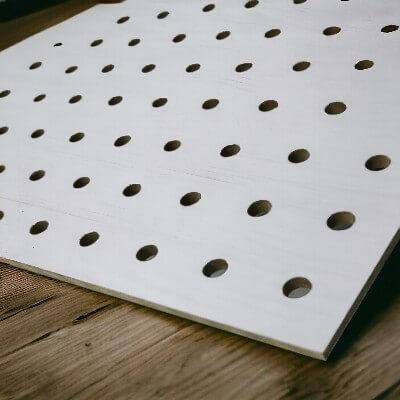 Image of a pegboard with small holes, typically 1/8-inch in diameter, suitable for lighter items and specific hooks