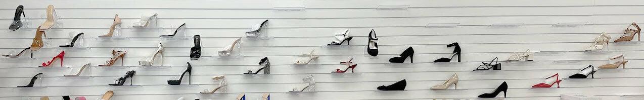 Slatwall panels displaying shoes in acrylic slatwall shelves