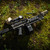 The FN-M249 M-LOK® Handguard, attached to a rifle, lying on the grass. Product made by Midwest Industries.