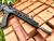 Lifestyle photo of the Galil Ace Smooth Variant Handguard, M-LOK™ lying against bricks. Product made by Midwest Industries.