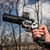 Close up of someone holding a firearm with the Smith & Wesson Red Dot Mount attached. Product made by Midwest Industries.