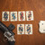 Several cards from the Bounty Hunter Playing Card Deck lie spread out on a table next to a firearm. Product sold by Midwest Industries.