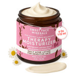 Sweet Face Minerals Acne Therapy Moisturizer in amber jar with pink label, open lid showing cream texture, surrounded by chamomile flowers, 4oz / 118ml size.