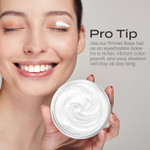 Model holding a jar of primer base gel with product applied to the eyelid, demonstrating use as an eyeshadow base for enhanced color payoff.