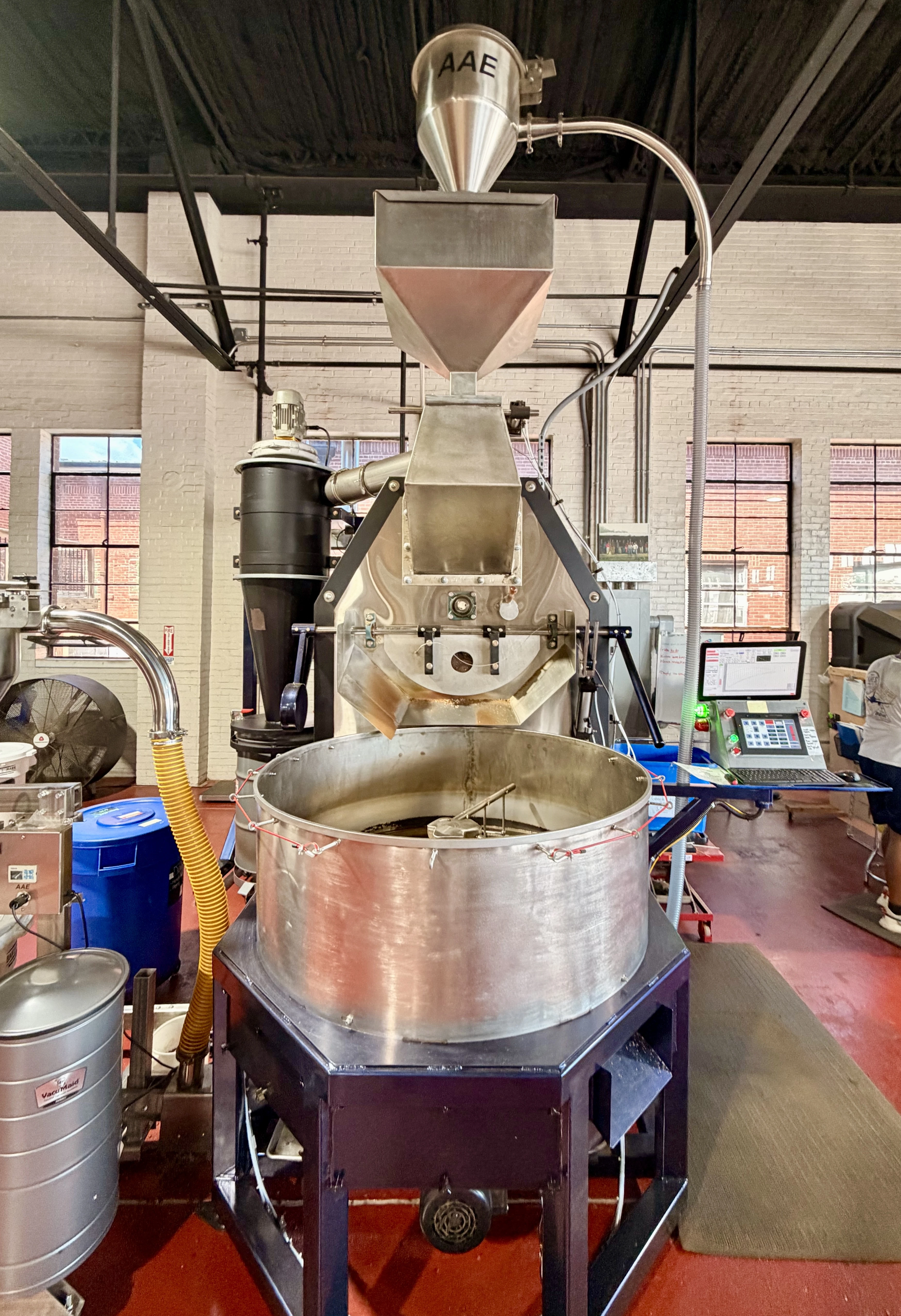 Freshly roasted organic coffee beans tumbling from the roaster at Campesino Organic Coffee in Americus, Georgia