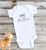 Customize this cute baby onesie body suit with the last name of the family or the baby's first name.