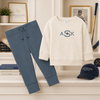 Little boy wearing a personalized blue organic cotton pullover and jogger set