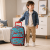 Little boy standing beside a turquoise race car rolling suitcase with red trim