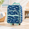 Shark print kids luggage in boutique coastal room setting