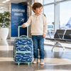 Child traveling with personalized shark rolling suitcase