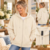 Woman modeling a cream full-zip hoodie with front zipper, drawstring hood, and relaxed unisex fit