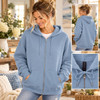 Woman modeling a Steel Blue zip-up hoodie with a relaxed silhouette and full-length zipper