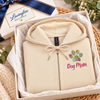 Cream embroidered Dog Mom zip-up hoodie with colorful floral bouquet displayed in a Lavington Designs gift box