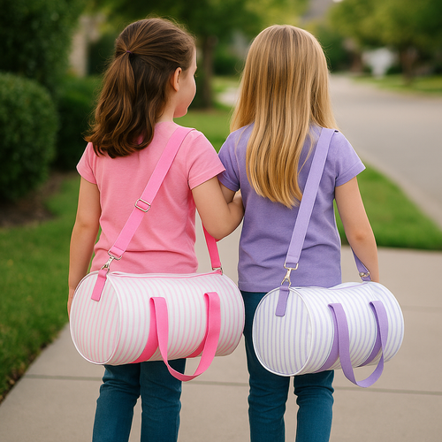 Lifestyle photo of a girl carrying a personalized kids duffle bag, perfect as a kids overnight bag for travel and sleepovers Lifestyle photo of a girl carrying a personalized kids duffle bag, perfect as a kids overnight bag for travel and sleepovers