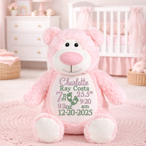 Child holding pink birth stat stuffed bear, personalized baby keepsake plush with embroidered details