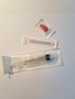 Sealed pre-sterilised luer lock syringe, cap and needle.