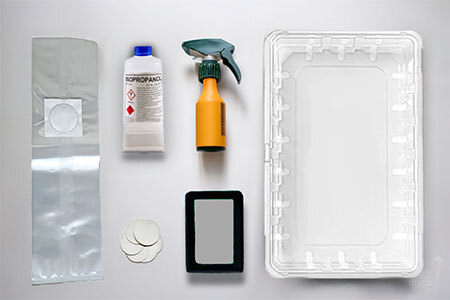 UK beginner mushroom growing equipment laid out flat including a clear tote, spray bottle, isopropyl alcohol, thermometer hygrometer, and fruiting bag