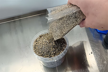 Brown rice flour and vermiculite substrate mixture being poured into a hypha flux pot ready for sterilisation and inoculation