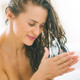 Woman applying Ginger Lily Farms Botanicals Moisturizing Conditioner coco mango to her hair 
