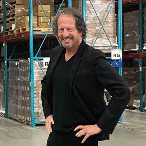 TNG Founder and CEO Larry Gaynor standing in a warehouse smiling.