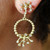Fireworks, gold and diamond earrings on the ear.  Fireworks, gold and diamond earrings on the ear.
