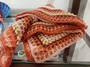 Close-up of Pink Sunset crochet blanket showing detailed handmade stitching, soft baby acrylic yarn and warm sunset colors