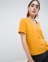 Boxy top with contrast buttons