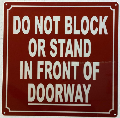 Do not block or stand in front of doorway Sign