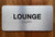 Lounge Sign with Raised Letters & Grade 2 Safety Sign