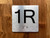 1R Elevator Jamb Plate Compliance Sign