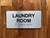 Laundry Room With Sign with Raised Letters Compliance Sign