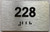 BRAILLE APARTMENT NUMBER 228 SIGN