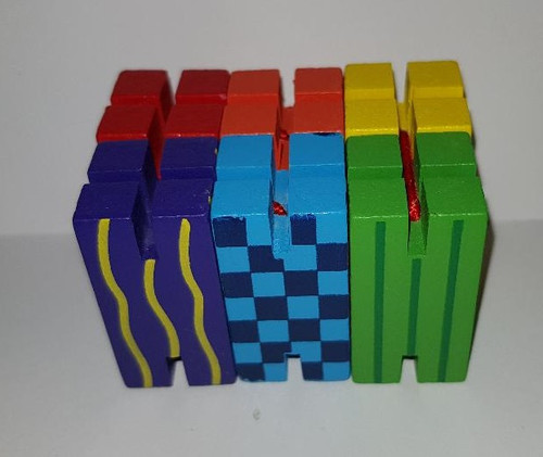 What'Zit - A multi-coloured, wooden fiddle toy! What'Zit is made up of 6 rectangular wooden blocks strung together with elastic to make different shapes What'Zit - A multi-coloured, wooden fiddle toy! What'Zit is made up of 6 rectangular wooden blocks strung together with elastic to make different shapes