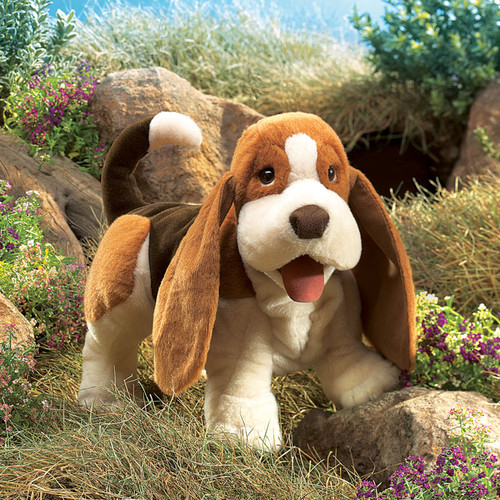 The Folkmanis Basset Hound Puppet  is an irresistibly cuddly and expressive puppet designed for interactive storytelling and imaginative play.

With its sad eyes and droopy expression, this plush pup practically begs for a warm hug—perfect for kids and adults alike! 

Features:
- Movable mouth and front legs for lifelike animation.
- Ultra-soft plush fabric in realistic Basset Hound colors—white, light brown, dark brown, and black.
- Sweet brown eyes, floppy ears, and a pink tongue for extra charm.
- Encourages creativity, communication skills, and emotional expression through play.

Dimensions Length 41 cm x Height 23 cm x Width 14cm

Ages 3+ years

Ideal for puppet shows, interactive storytelling, sing-alongs, and pretend play.