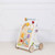 Introduce your little one to a world of adventure and learning with the Petilou Activity Walker by Le Toy Van. T
his beautifully crafted wooden walker is designed to support your child’s early development while providing endless fun.
 Adorned with charming woodland animals and a delightful nature garden theme, this walker is as beautiful as it is functional.
 The front panel boasts 10 engaging play features, including gears, peekaboo flaps, and more, to stimulate your child’s curiosity and motor skills.
Each side of the walker includes additional play activities, enhancing the overall play value.
A convenient fabric sling allows toddlers to store their favorite toys and take them along on their adventures.
 Winner of the 2019 Loved by Parents Best Wooden Toy award for children aged 1-3 years.
Made from sustainable rubberwood and decorated with child-safe, water-based paints.
Encourage your child’s development and provide hours of entertainment with the Petilou Activity Walker.
Perfect for adventurous toddlers, this walker is a must-have addition to any playroom.
Ages 12 months + Introduce your little one to a world of adventure and learning with the Petilou Activity Walker by Le Toy Van. T
his beautifully crafted wooden walker is designed to support your child’s early development while providing endless fun.
 Adorned with charming woodland animals and a delightful nature garden theme, this walker is as beautiful as it is functional.
 The front panel boasts 10 engaging play features, including gears, peekaboo flaps, and more, to stimulate your child’s curiosity and motor skills.
Each side of the walker includes additional play activities, enhancing the overall play value.
A convenient fabric sling allows toddlers to store their favorite toys and take them along on their adventures.
 Winner of the 2019 Loved by Parents Best Wooden Toy award for children aged 1-3 years.
Made from sustainable rubberwood and decorated with child-safe, water-based paints.
Encourage your child’s development and provide hours of entertainment with the Petilou Activity Walker.
Perfect for adventurous toddlers, this walker is a must-have addition to any playroom.
Ages 12 months +