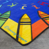 Alphabet Crayon Carpet with Blue crayon accents for daycare reading zones