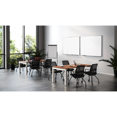 Modern rectangular conference table in walnut finish with contemporary leg bases in a professional corporate meeting room