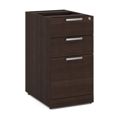 Deluxe office pedestal file cabinet in modern walnut finish positioned beneath an executive office desk in a professional workspace