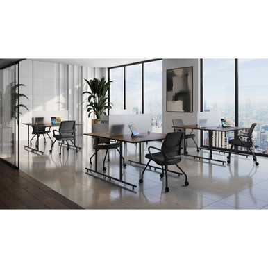 Classroom training tables with acrylic privacy screens arranged in a modern university testing center environment