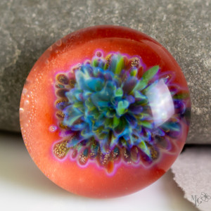 All the beautiful fresh colors of spring gathered together in the center of this boro lampwork cabochon