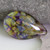 Green, Purple, Mango glass cabochon in a tear drop shape.  The brighter the light you view it the better the colors are. 20mm long by16mm wide