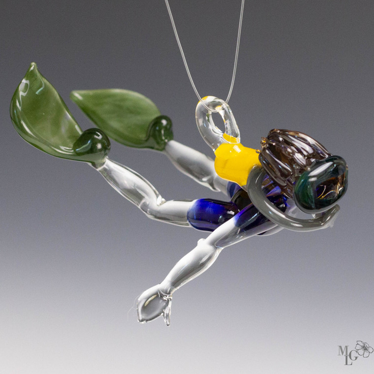 Scuba Dude - Jeffrey

Fun glass ornament. He has medium brown hair that is translucent so it sparkles in the sun

His mask is an interesting color. Sometimes it looks like a smokey charcoal grey. Sometimes you can see the rain forest green.