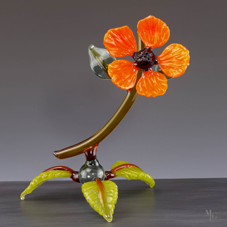 You can almost smell the sweet fragrance of orange blossoms while looking at this happy sunburst glass wildflower. From the color to the design this compact botanical delights the senses