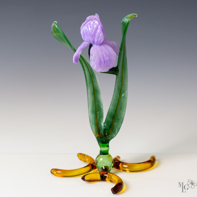 Sleek ruffled lavender glass petals grace the elongated iris flower sculpture. Her beauty is dignified, full of grace, beauty and charm