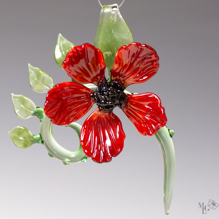 Bright red glass flower bloom takes center stage on a green spiral vine with multiple leaves. Ready to hang in your favorite sunny location