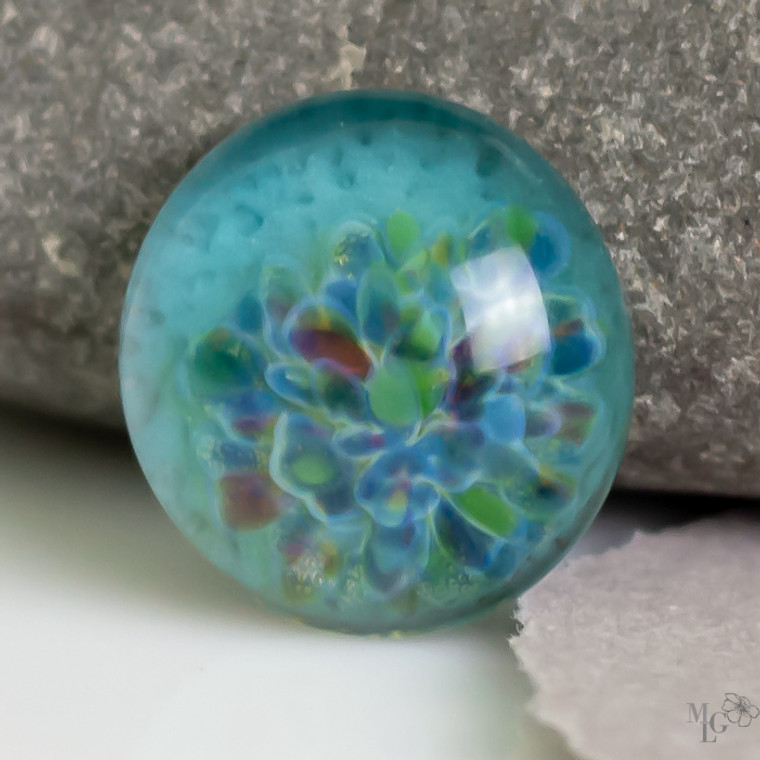 Soothing aqua glass mixed with happy spring colors create this chill little 17mm glass cabochon