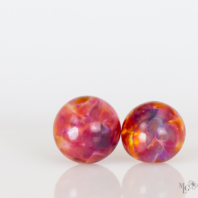 Pink implosion lampwork glass earring studs. The more light that surrounds them the more they come alive! 9mm studs