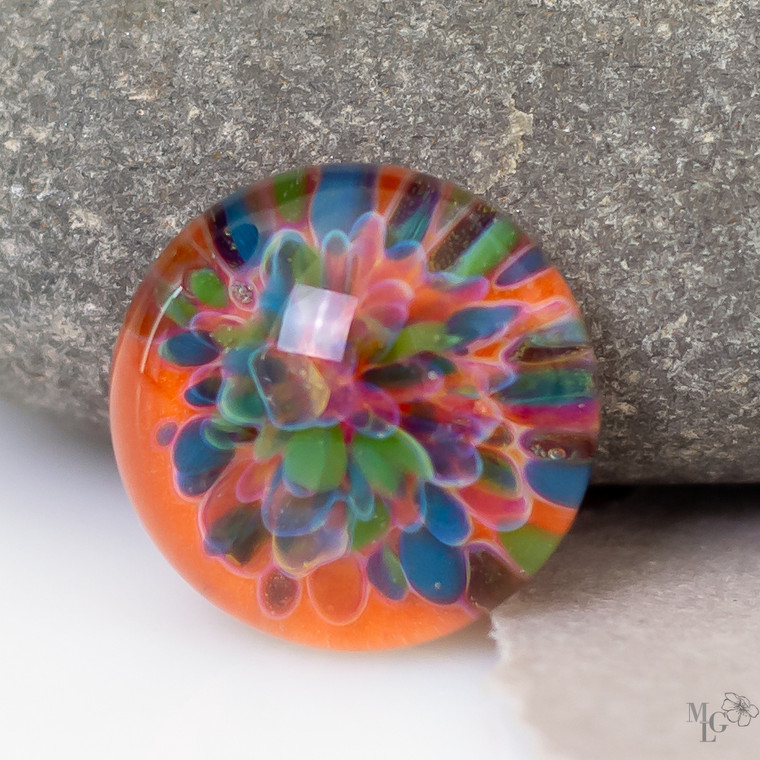 Glowing orange glass cabochon with an implosion of spring colors that draw you in for a second and third look. 17mm boro lampwork jewelry component