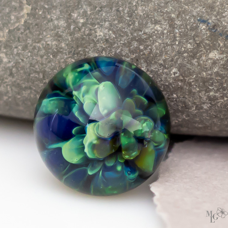 What a bountiful grouping of various greens in this little round 15mm glass cabochon. It has such a wonderful freshness to it