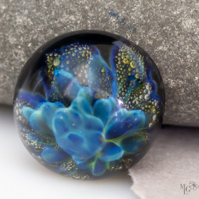 What a wonderful celebration of color and form! The blues seem to dance while the gold  rises in effervescence. The clear dome on this 18mm glass cabochon is high and round